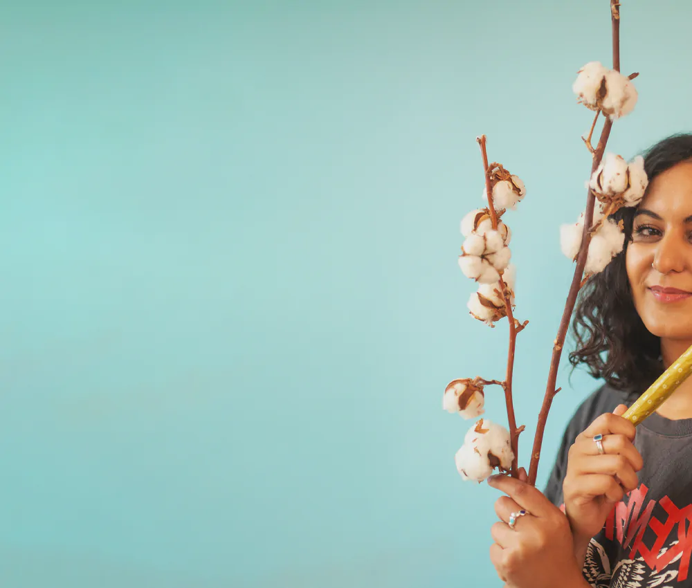 woman holding organic cotton and a natracare tampon