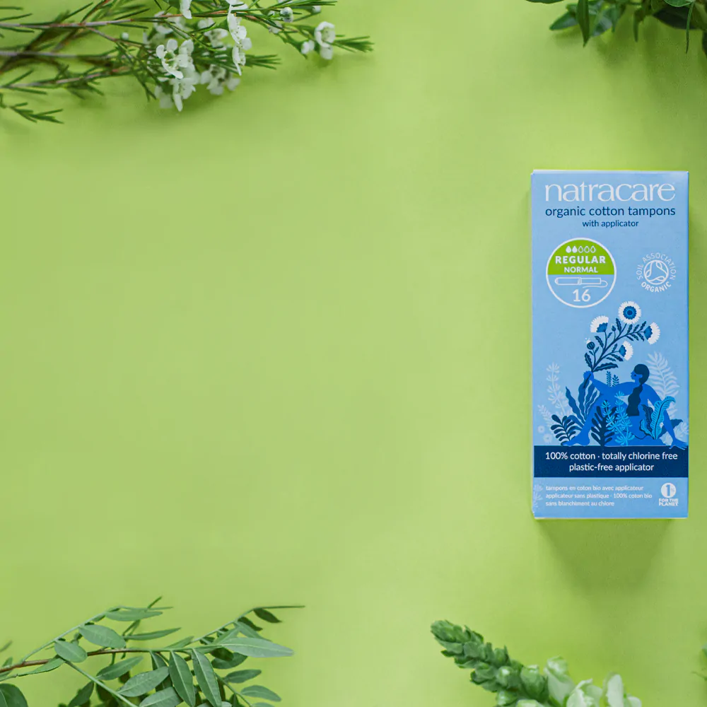 a pack of natrcare organic cotton tampons surrounded by plants