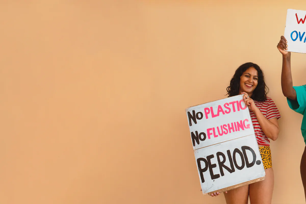 women holding #periodpower signs