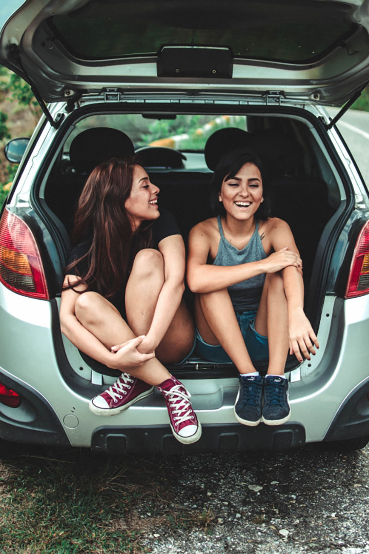 two females happy in car