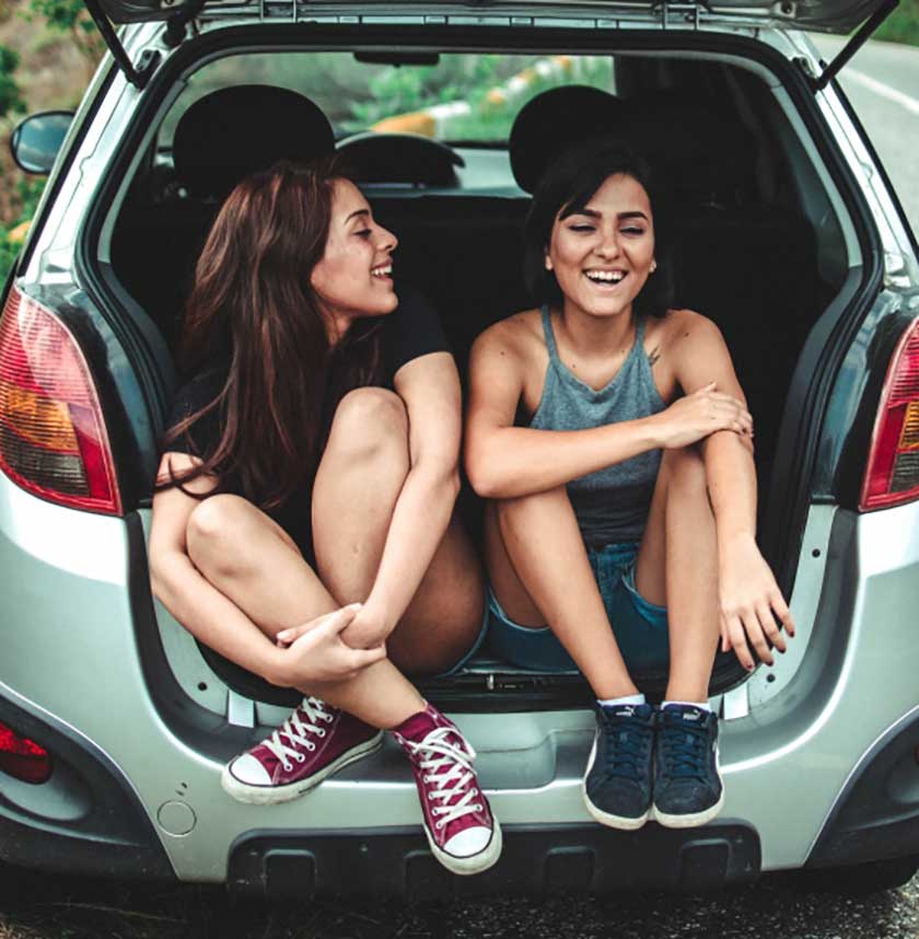 two females happy in car