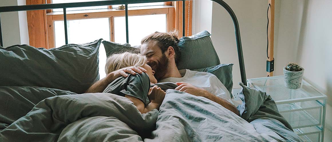 couple cuddling in bed