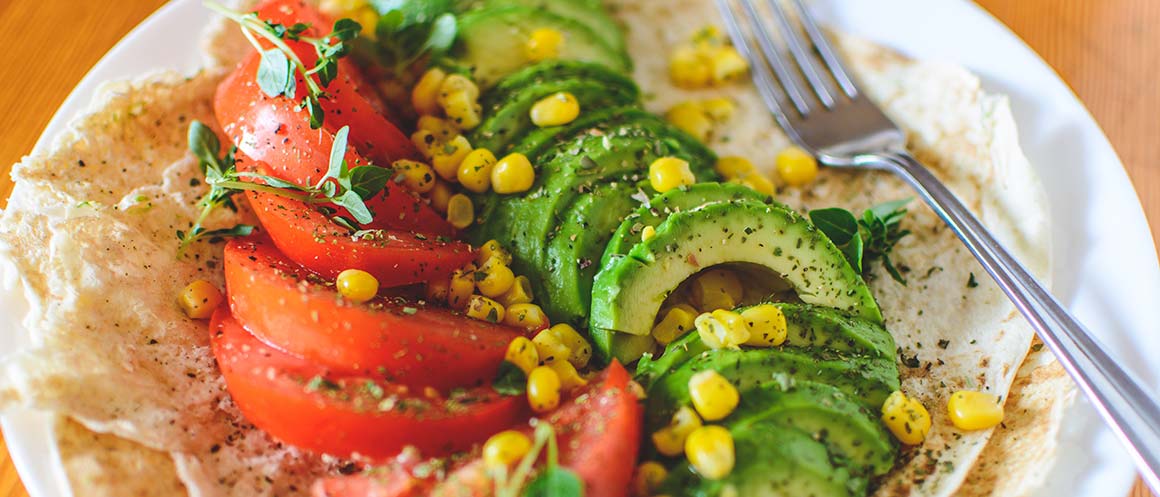 vegan avocado tomato and sweetcorn wrap