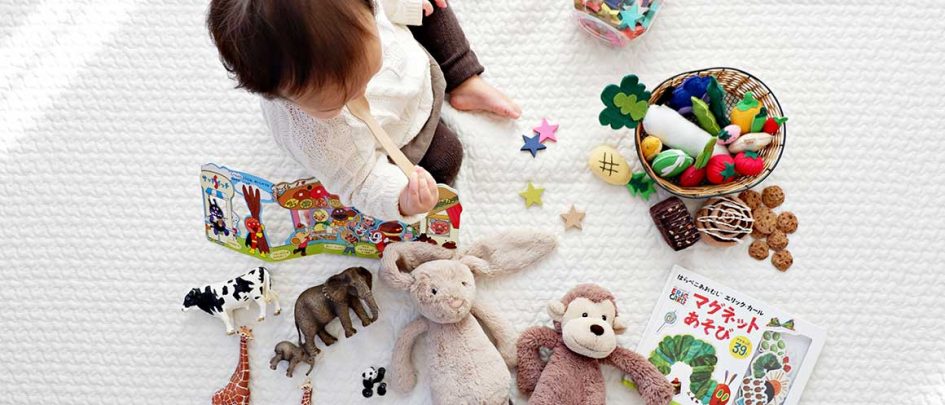 baby surrounded by toys