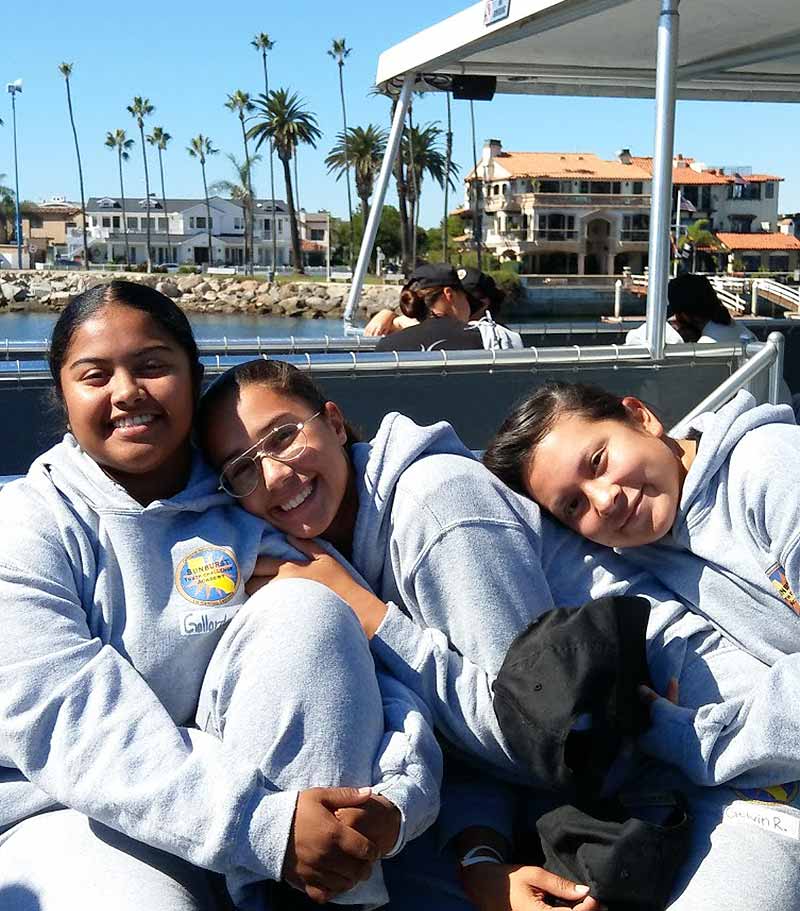 3 girls smiling on boat
