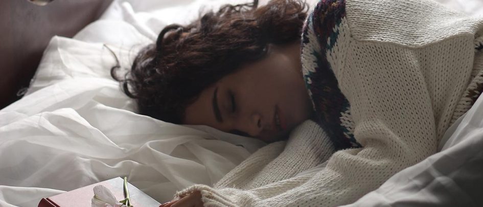 girl sleeping on bed in daytime