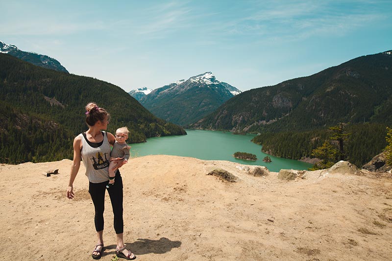 Woman looking over lake with baby