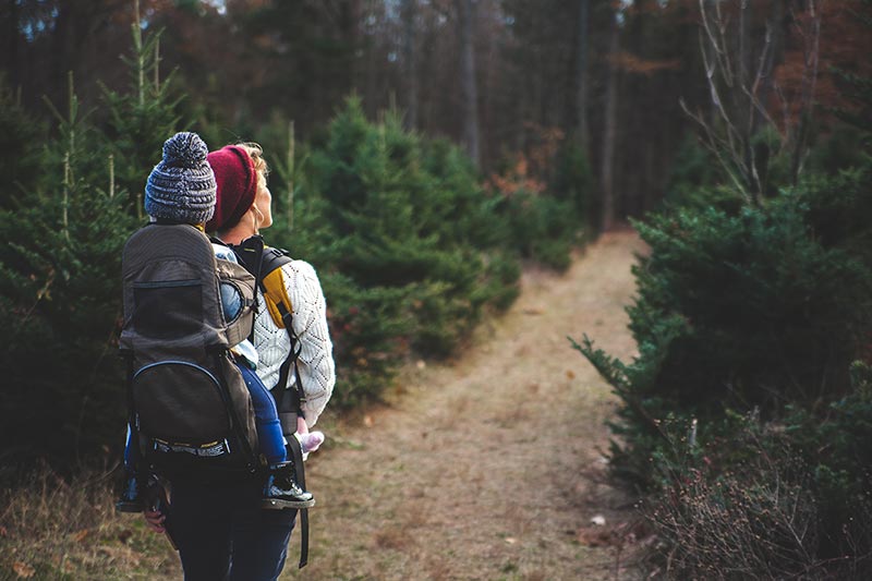 Woman hiking with baby on her back 