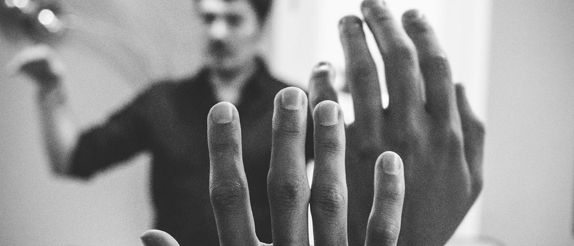 boys raising hands in classroom