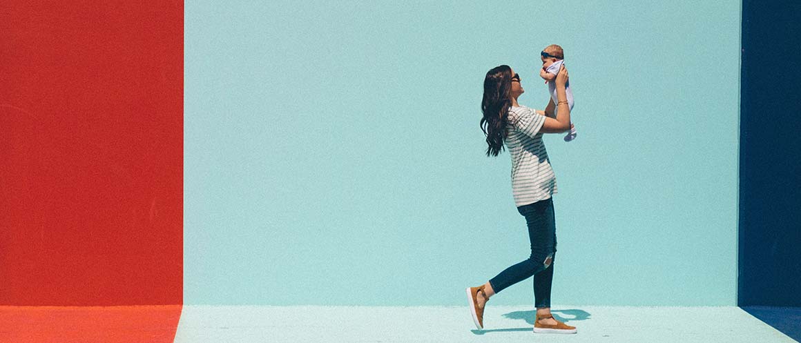 mother walking while carrying child