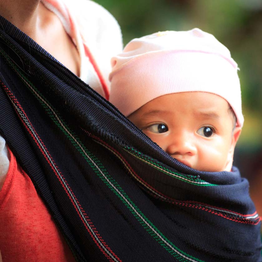 baby in hat and sling