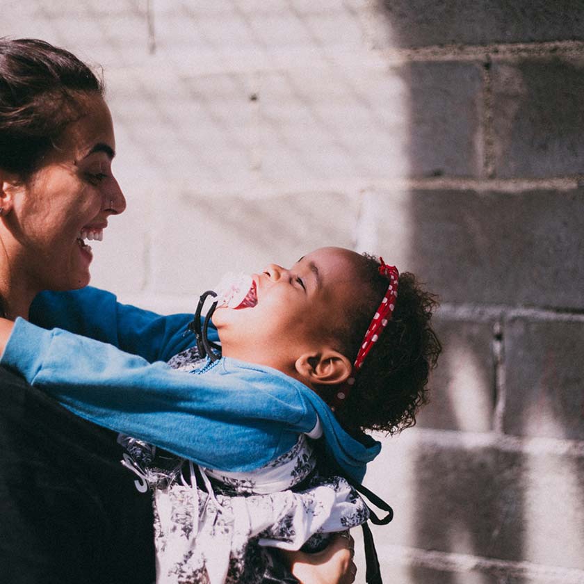 baby and mum laughing together