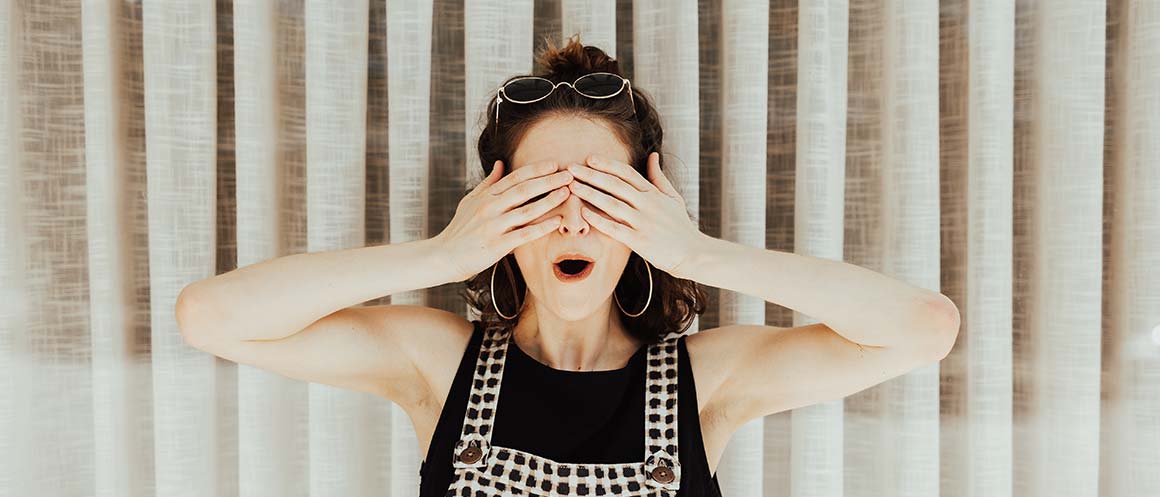 women with hands over her face in disbelief
