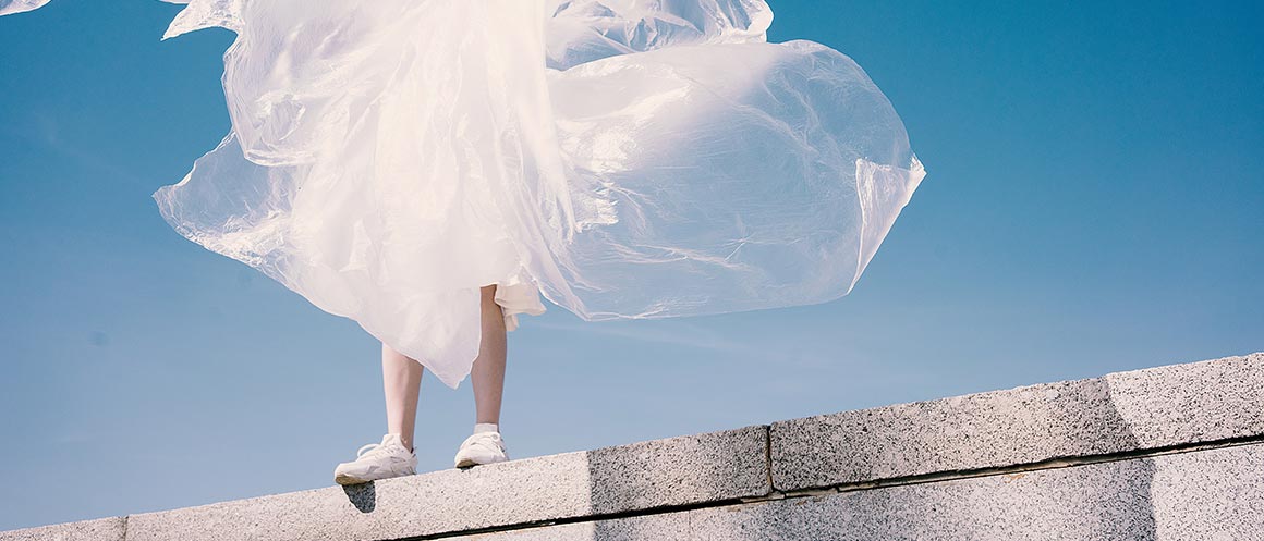 woman stood in wind with plastic