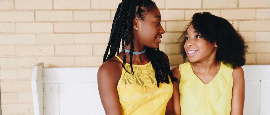 Two young girls looking at each other