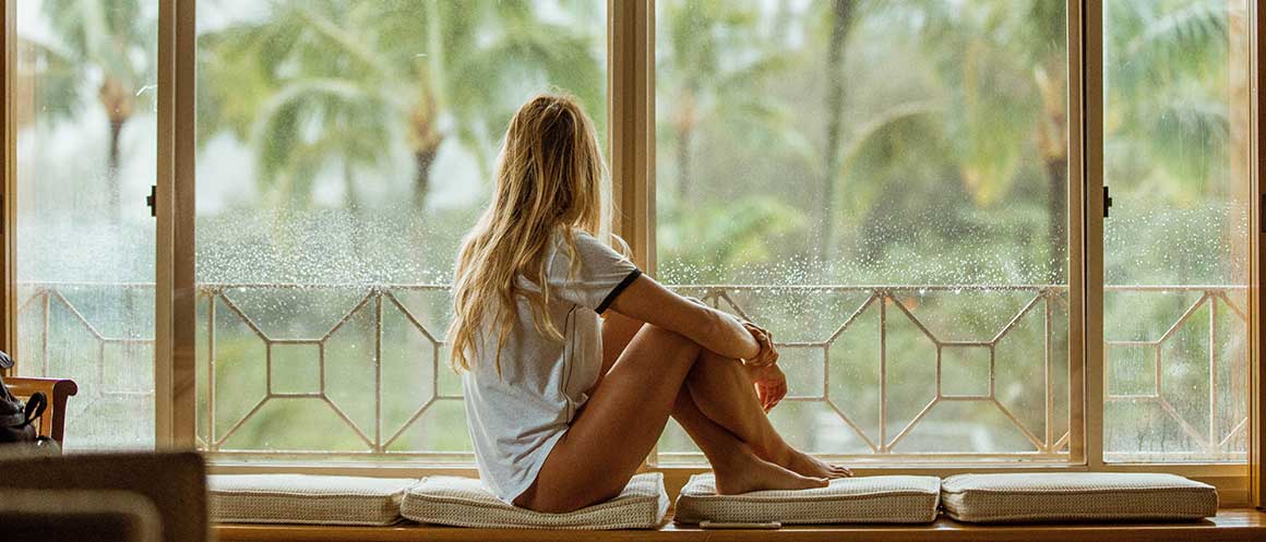 girl sat by window