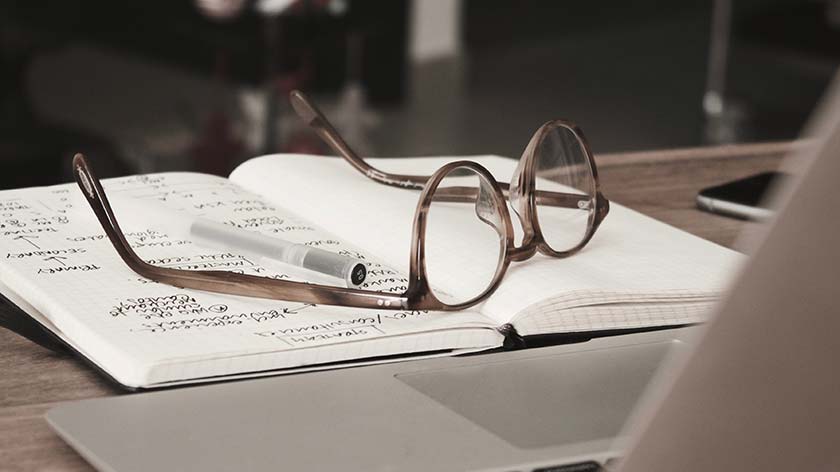 A pair of glasses on a notepad