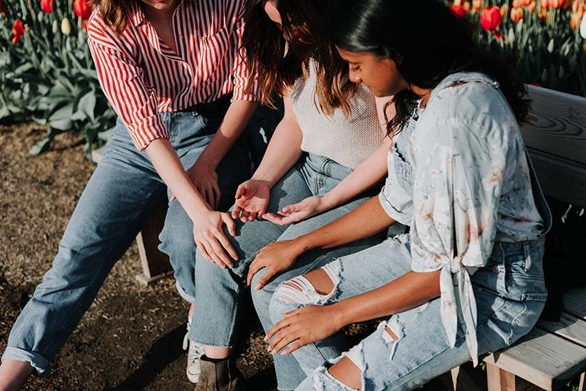 Three female friends sitting together