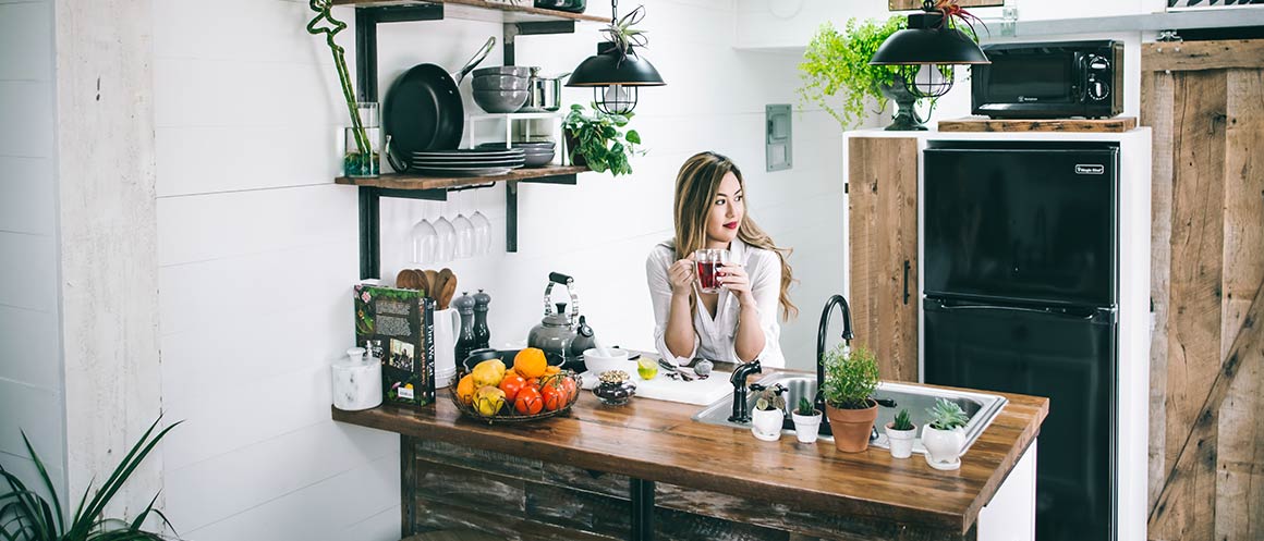 woman holding mug in kitchen