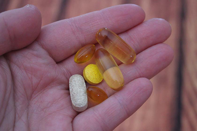person holding diet supplements