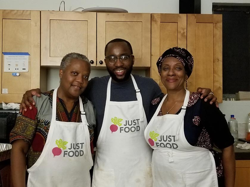 people in Just Food aprons hugging