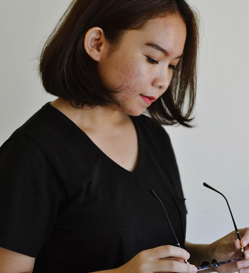 teenage girl holding glasses