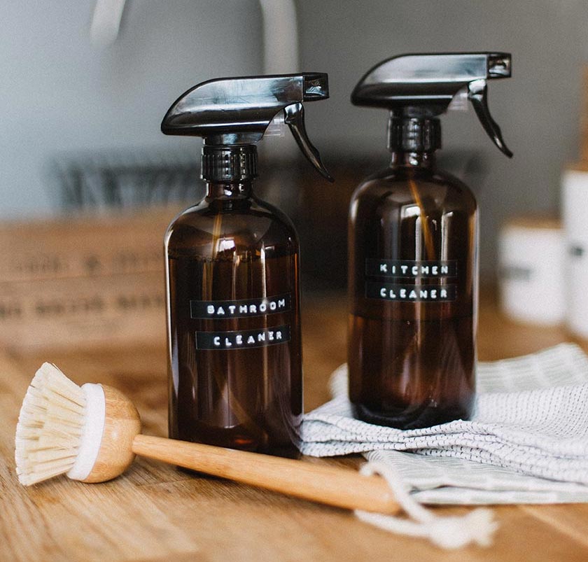 bottles of cleaning solution and a scrubbing brush