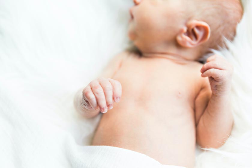 newborn baby lying on its back