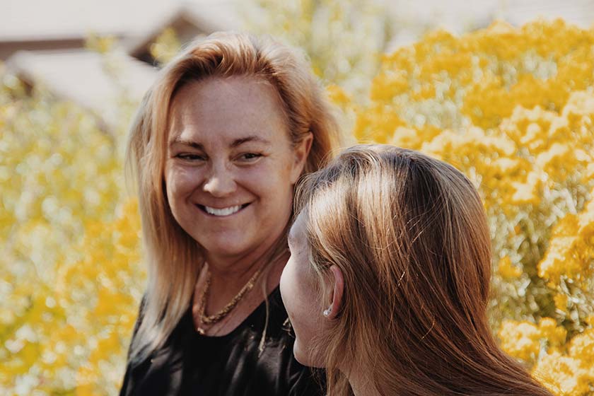 mother and daughter laughing in nature