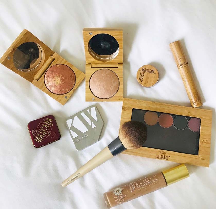 makeup and brushes on bed