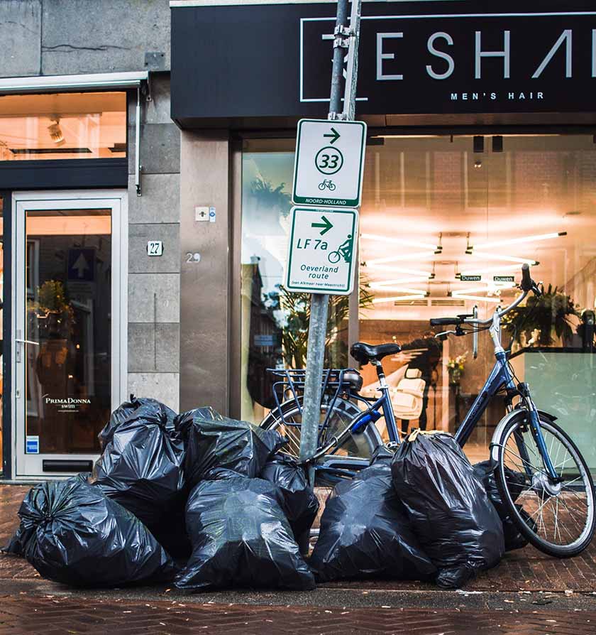 piles of trash bags on the street