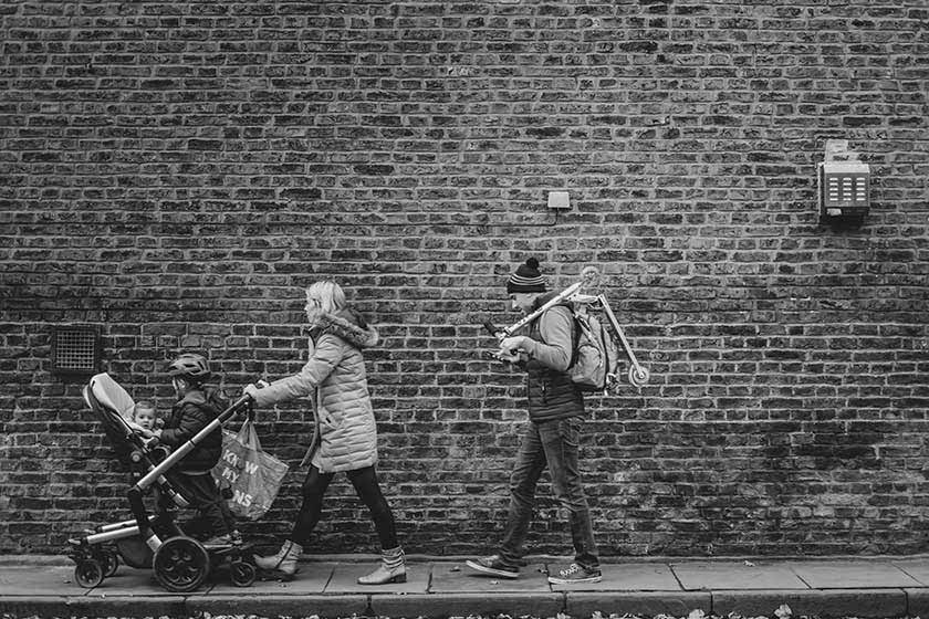 family out walking with prams and scooters