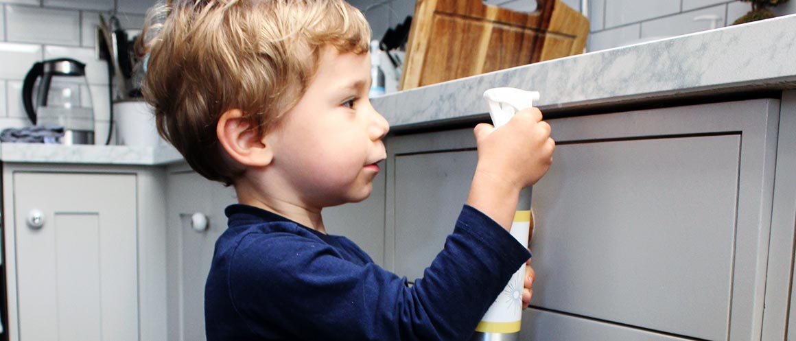 child cleaning kitchen drawers