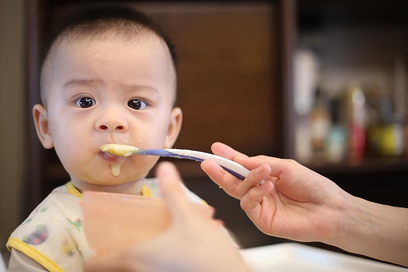 baby being fed with spoon