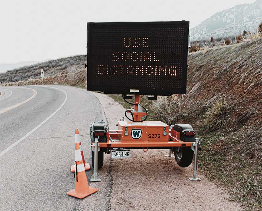 social distancing road sign