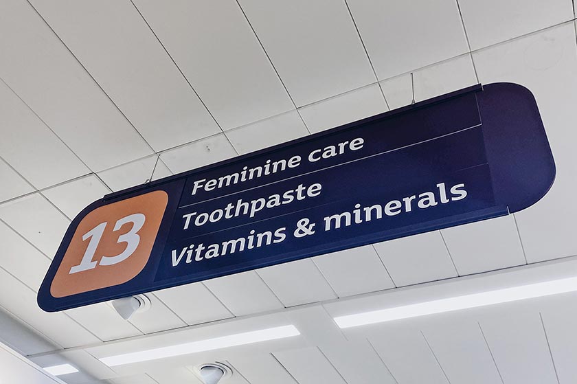Supermarket aisle sign with the words feminine care