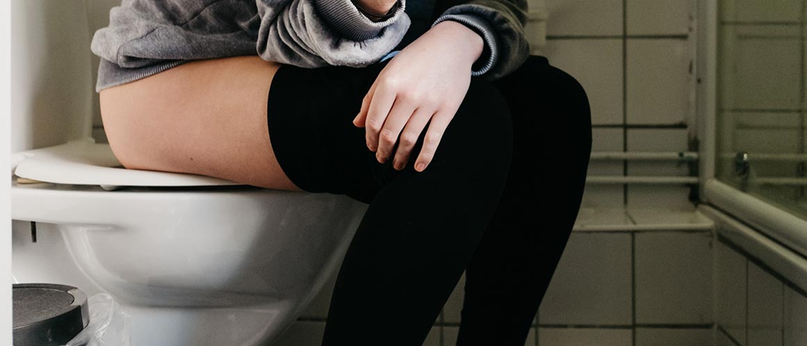 girl sat on toilet