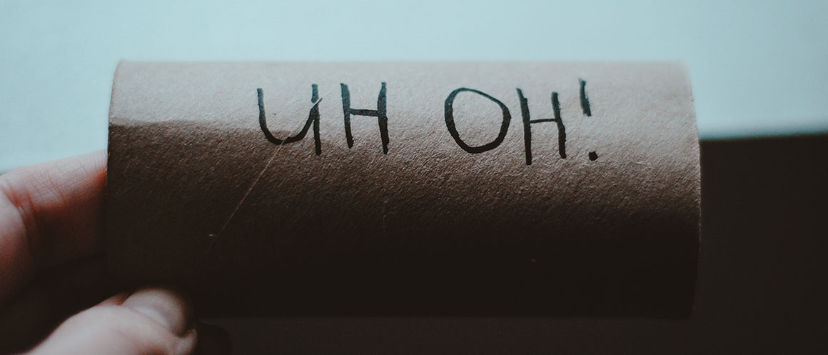 empty toilet roll with "uh oh!" written in pen