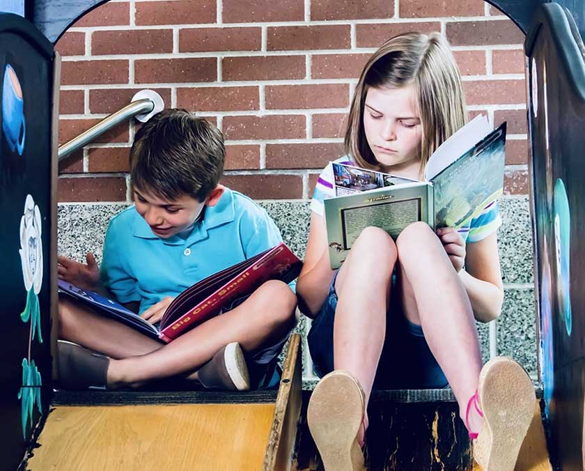 two children reading books