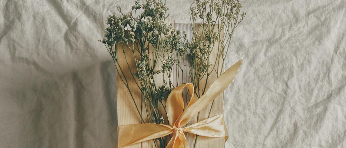 gift in wooden box with flowers and ribbon