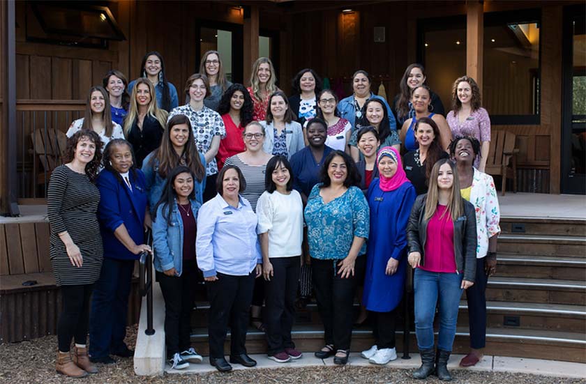 A group of WEA program participants stood together, smiling for a team photo