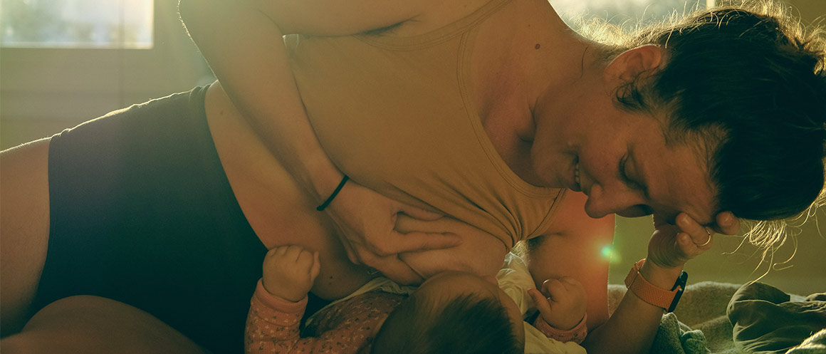 person breastfeeding their baby