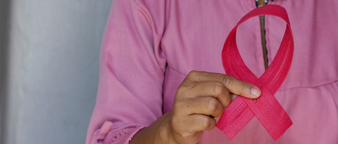person holding breast cancer awareness ribbon