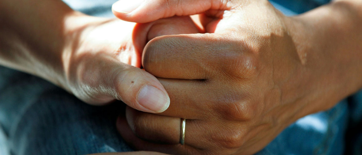 two hands holding in support