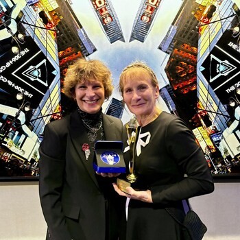 Susie Hewson with gold and silver Stevie Award with her sister Theresa White